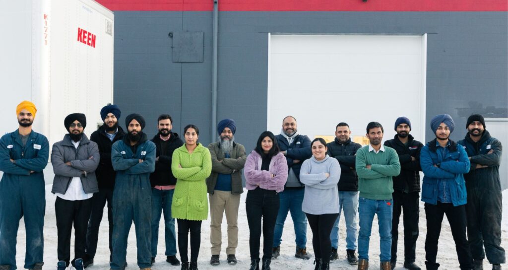 A group of team members from a trucking company in Winnipeg Manitoba standing together